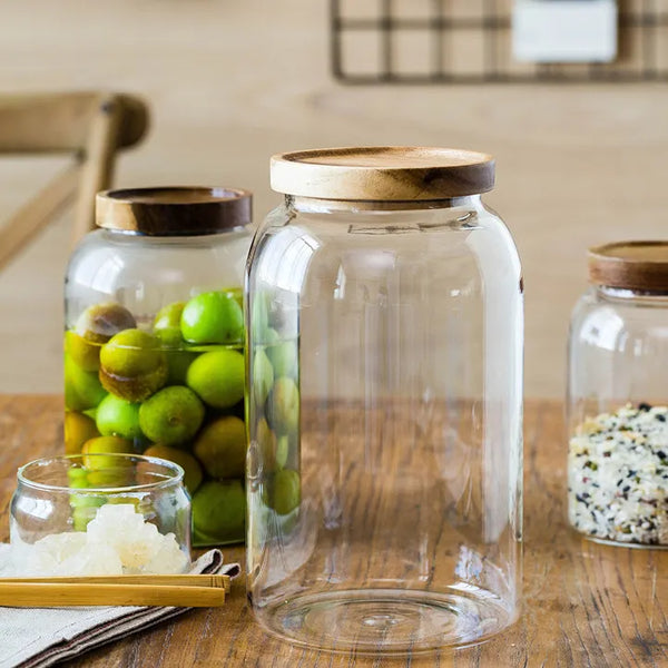 3000ml and 1500ml clear glass jars with airtight bamboo lids, one filled with olives and water, showcasing two size options