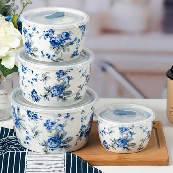 Showcasing 4 ceramic bowls stacked on top of each other, each with a blue floral design and sealed with a silicone lid for airtight food storage.