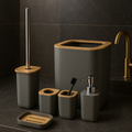 Bathroom accessories set with gray containers and wooden accents on a dark tiled wall.