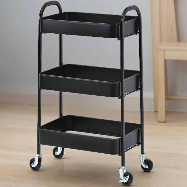 A black 3 compartment kitchen trolley made of metal, featuring three shelves and four caster wheels for mobility.