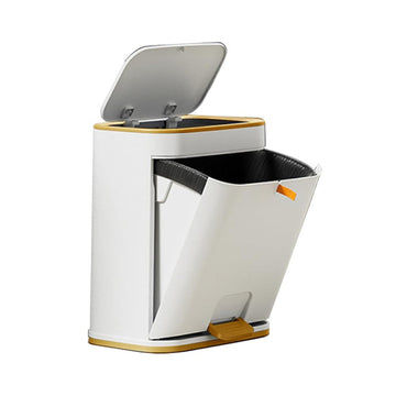 A white bathroom trash can with a gold accent, featuring a double-opening lid design, one of which is foot pedal operated. The trash can appears modern and is partially open.