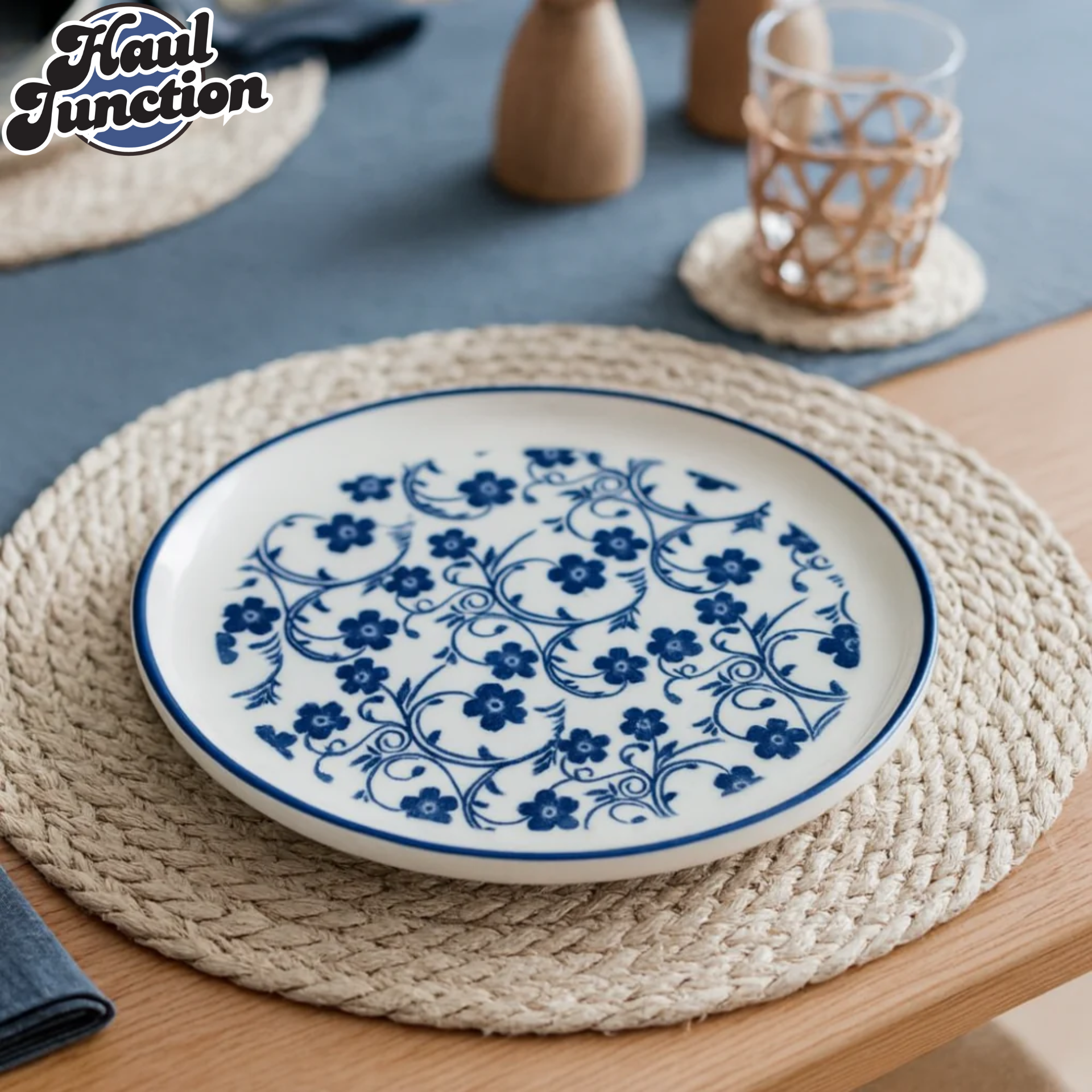 Blue and white floral-patterned plate on a woven placemat with 'Haul Junction' branding.