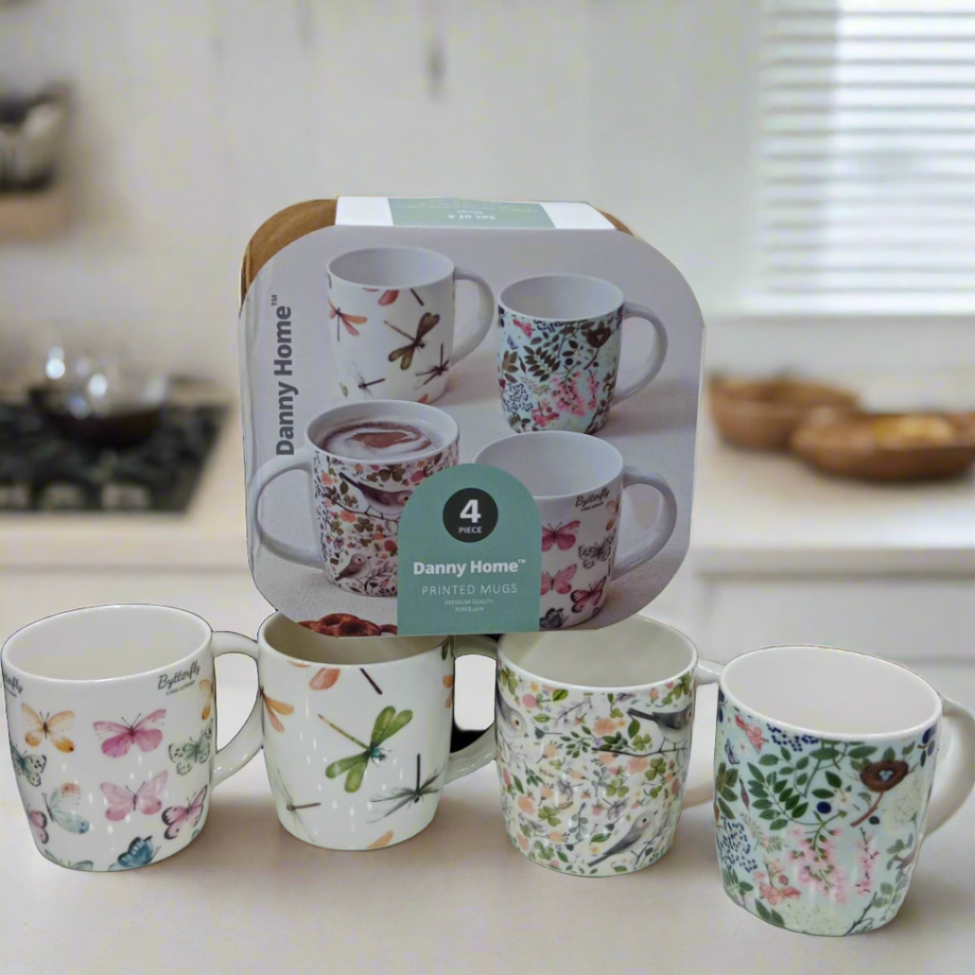 Box packaging for Danny Home™ 4 Pcs Printed Mugs, with four mugs displayed outside the packaging.