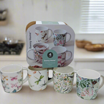 Box packaging for Danny Home™ 4 Pcs Printed Mugs, with four mugs displayed outside the packaging.