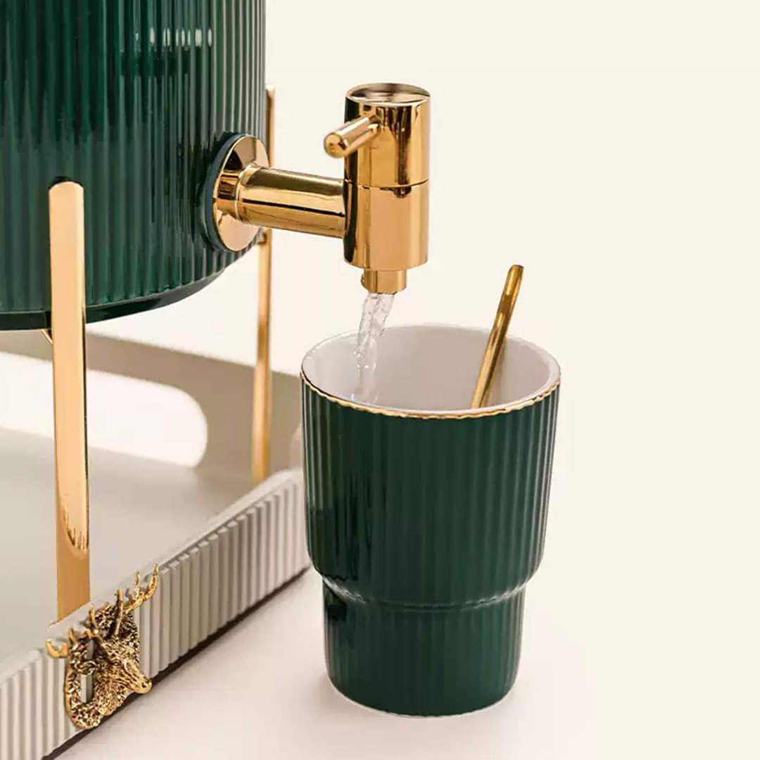  Close-up of a cup being filled with water from the dispenser, with a golden spoon beside it, emphasizing the luxurious details.