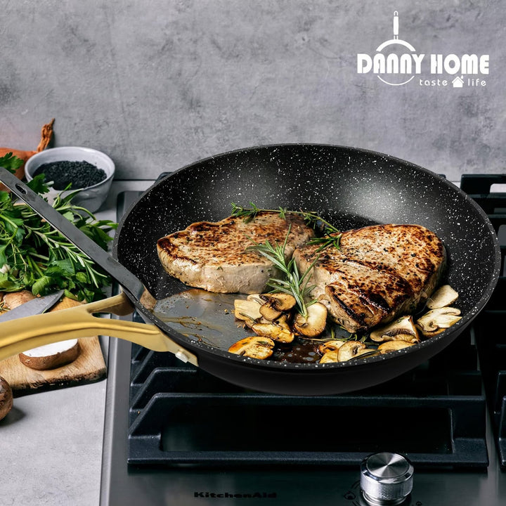 Danny Home™ Aluminum Frying Pan Black on stove with steaks cooking. The pan features eco-friendly non-stick technology for easy cooking and cleaning.