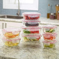 Four sizes of HaulJunction Air Tight Glass Food Containers, each with two containers filled with fresh fruits and vegetables, sealed with airtight lids for optimal freshness.