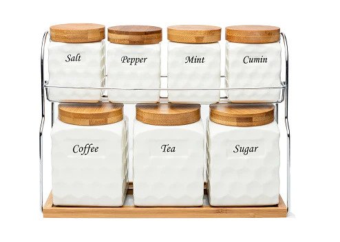 Showcasing the set of 7 ceramic storage jars placed on a steel stand with a wooden base, featuring wave texture, labeled jars, and wooden lids, all in a white background.