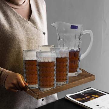 4 glasses and 1 jug from the Geometrical Style 6-Piece Glass & Jug Set displayed on a tray, highlighting the elegant geometric design and transparent glass material.