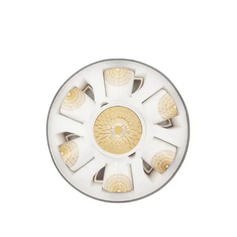 Golden ceramic cup and saucer set displayed in open box packaging, showcasing six elegant pieces ideal for stylish tea and coffee serving.