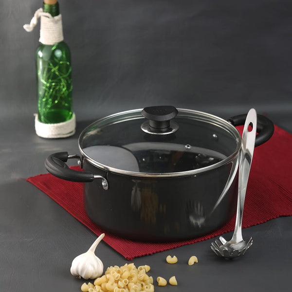 Hard anodised sauce pot with lid placed on a tabletop, showcasing its sleek design and non-stick surface.