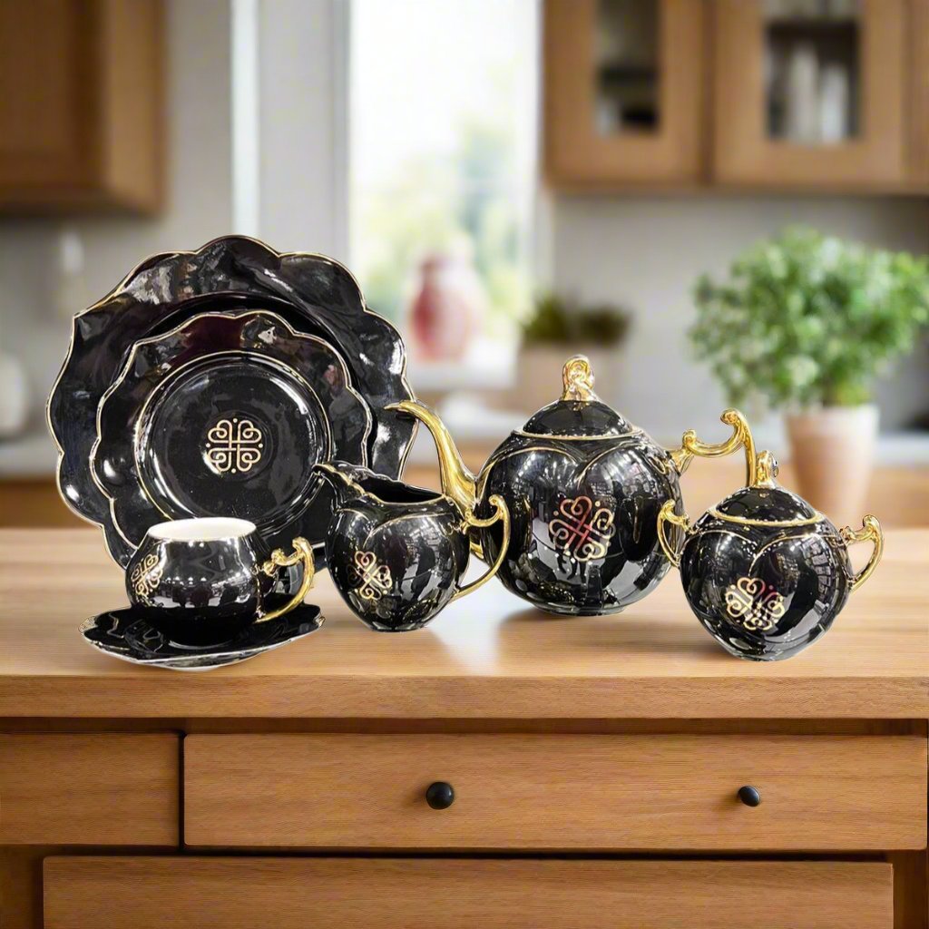 Modern all-black ceramic floral teaset, featuring black plates, mugs, kettle, and pots with an elegant floral design. Includes a complete 18-piece set perfect for sophisticated tea settings.