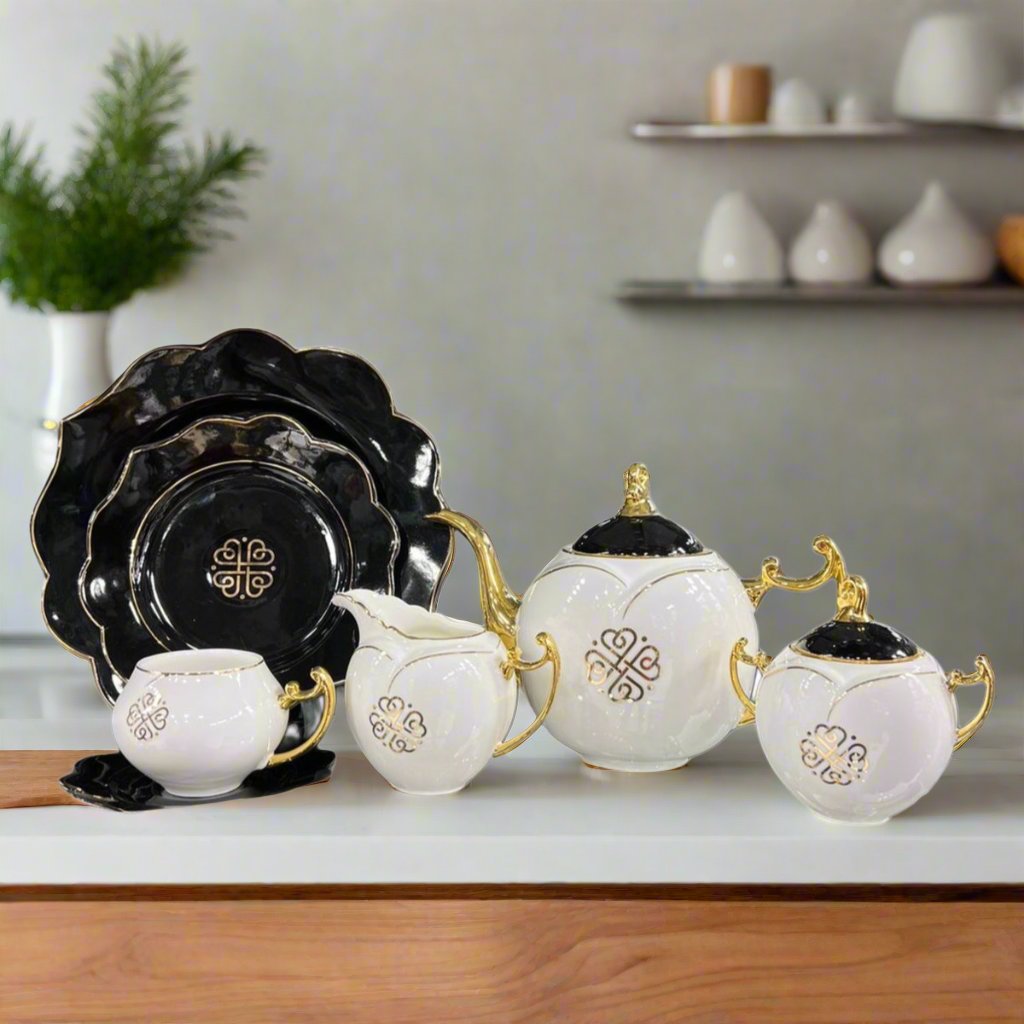 Modern ceramic floral teaset featuring black plates, white pots, mugs, and a kettle with a floral design. All pots include black lids, totaling 18 pieces: teapot, sugar pot, creamer, flat plates, tea cups, and saucers. Perfect for elegant tea settings.