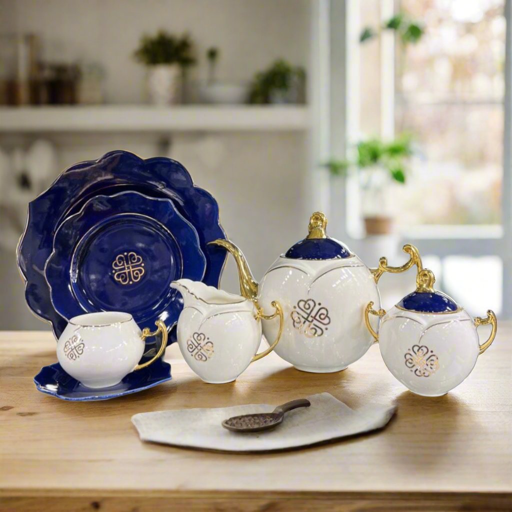 Modern ceramic floral teaset featuring blue plates, white pots, a kettle, and mugs with a sleek modern design. A complete 18-piece set perfect for stylish tea gatherings.