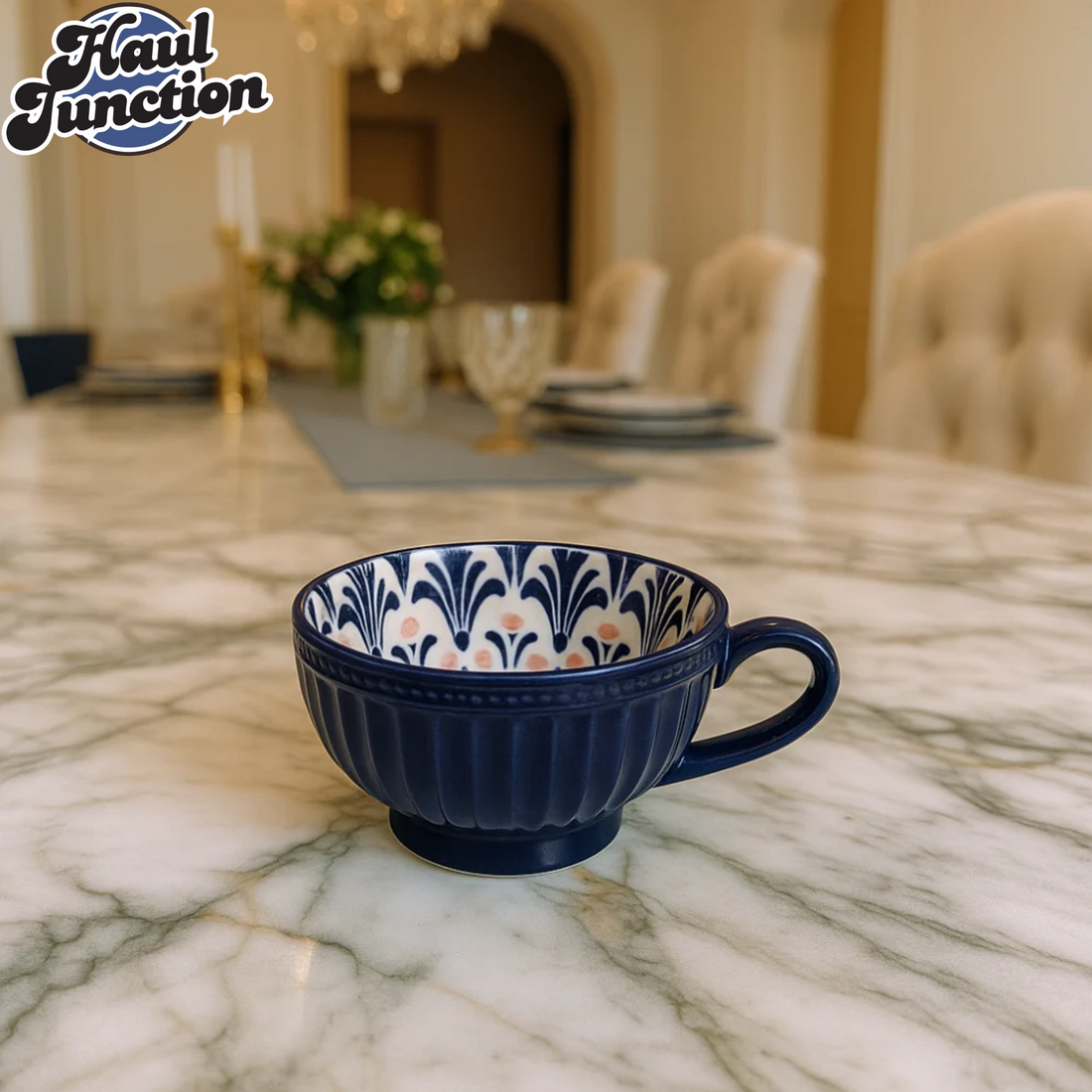 Navy blue cup with floral pattern on a marble table, 'Haul Junction' logo visible