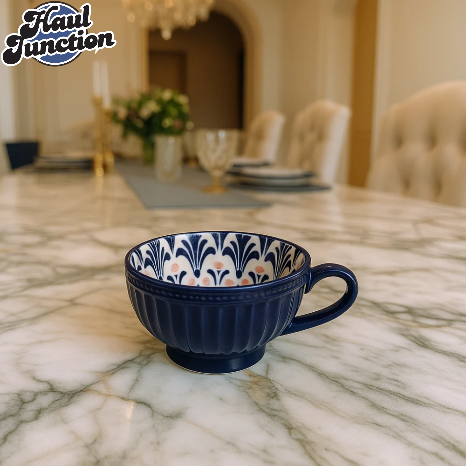 Navy blue cup with floral pattern on a marble table, 'Haul Junction' logo visible