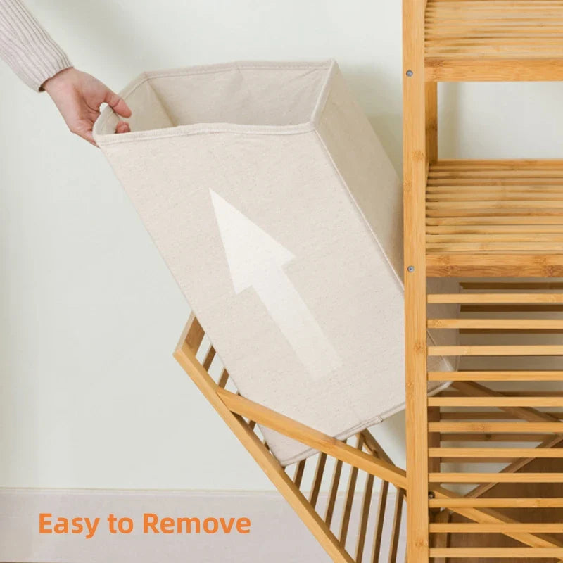 Woman using a wooden laundry basket with a shelf in a room.