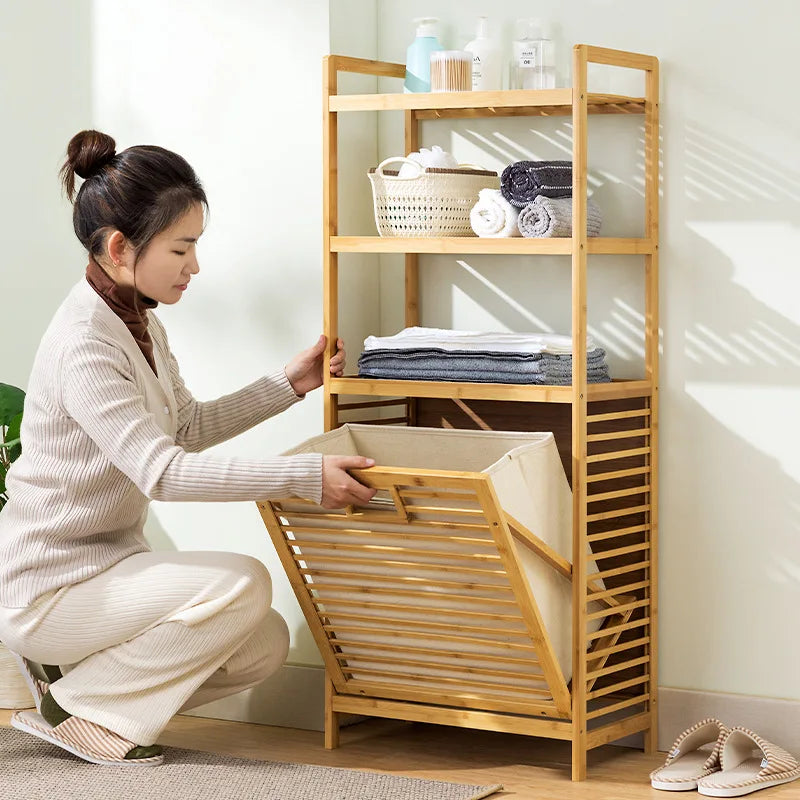 Woman using a wooden laundry basket with a shelf in a room.