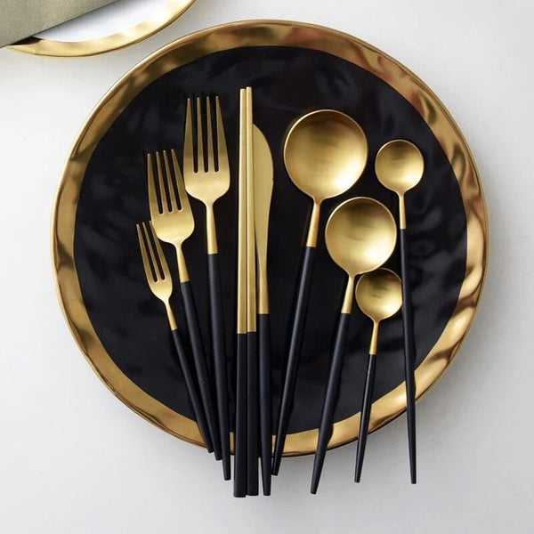 Showcase the full options 24-piece set on a black and gold plate. The set includes knife, fork, and spoon, highlighting the elegant compatibility of the cutlery.