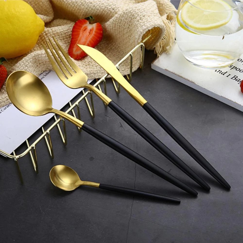 Showcase the set of four pieces (fork, knife, big spoon, and small spoon) on a stand, emphasizing their versatility and elegance.