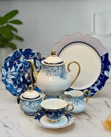 Showcasing 24Pcs Fine Bone China Tea Set with blue pattern, featuring tea pot, tea cups, saucers, flat plates, and sugar pot. Elegant design by HaulJunction.