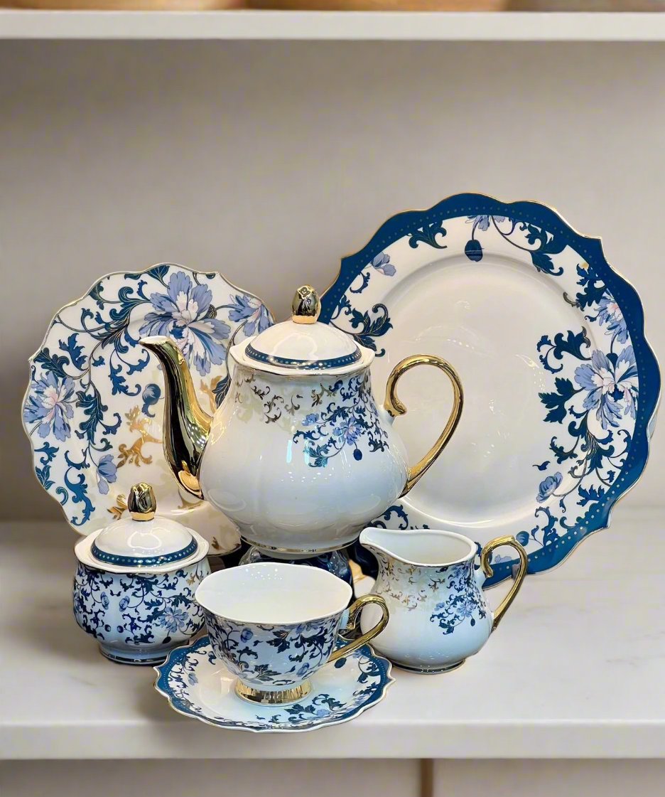 Showcasing the elegant 24Pcs Fine Bone China Tea Set with a blue floral pattern featuring a tea pot, tea cups with saucers, and plates. Perfect for serving tea in style, available at HaulJunction Pakistan.
