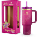 Stanley x Barbie '70s Superstar Quencher 40 Oz pink tumbler with a straw, presented next to its packaging featuring Barbie's image.