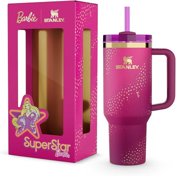 Stanley x Barbie '70s Superstar Quencher 40 Oz pink tumbler with a straw, presented next to its packaging featuring Barbie's image.