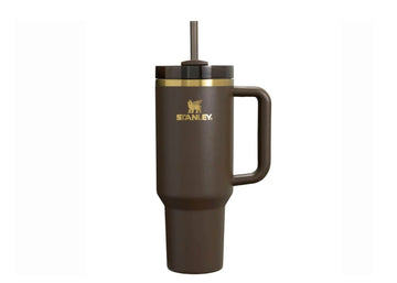 A brown Stanley Quencher Tumbler with a handle and a straw spout, featuring a gold accent on the lid.