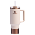 A white and gold colored tumbler with a handle and a straw spout, featuring the Stanley brand logo.