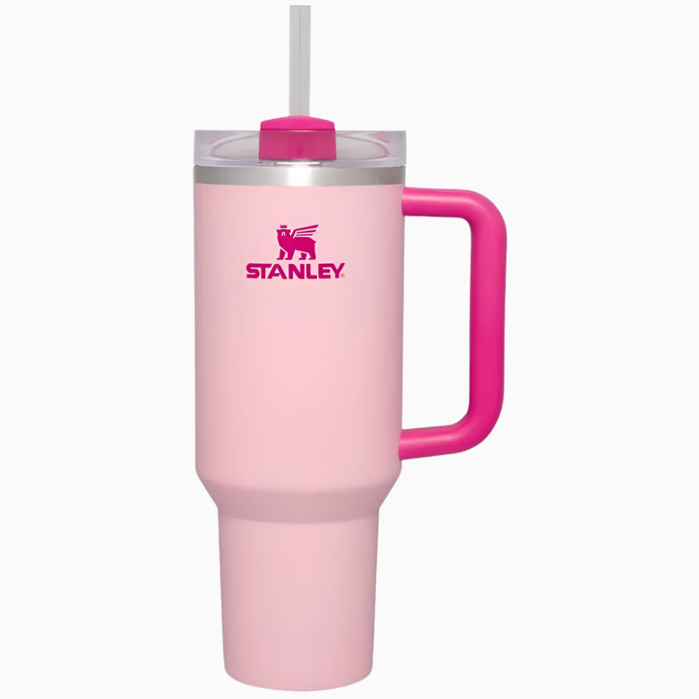 Pink Stanley tumbler with a handle on a white background