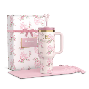 A pink floral-patterned tumbler with a FlowState lid, displayed alongside its packaging box and a pink fabric coaster.