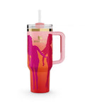 A pink and red Stanley Quencher Tumbler with a handle and a straw, designed to keep drinks cold or hot.
