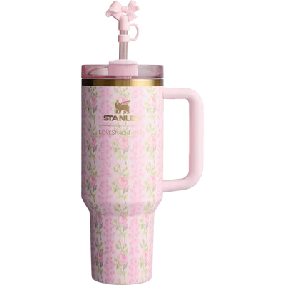A pink Stanley Quencher Tumbler with a floral pattern and a straw spout on the lid.