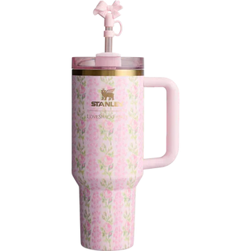 A pink Stanley Quencher Tumbler with a floral pattern and a straw spout on the lid.