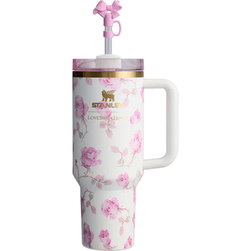 A white stainless steel Stanley Quencher tumbler with pink floral pattern and a pink lid and straw.