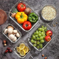 Top view of HaulJunction’s four sizes of food containers, filled with fresh fruits and vegetables, with securely sealed airtight lids, perfect for food storage.