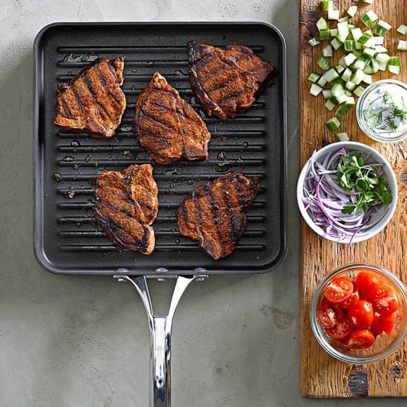 Non-stick square grill pan with perfectly cooked steak on it, showcasing delicious sear marks.