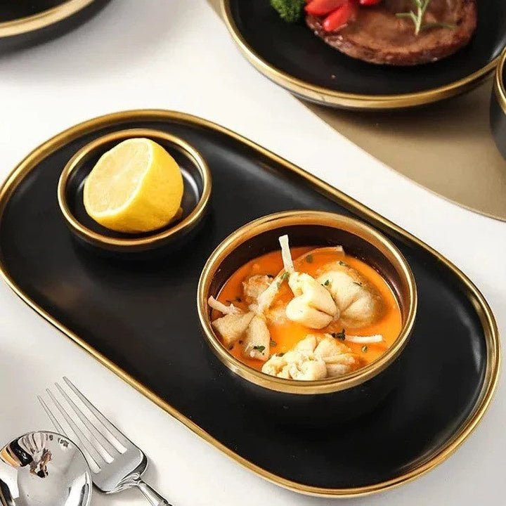 Tray with two bowls, one small sauce bowl with cut lemon on it and a normal serving bowl filled with curry.