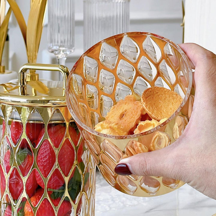 View from above of small jar with cookies inside and lid open, hand visible.