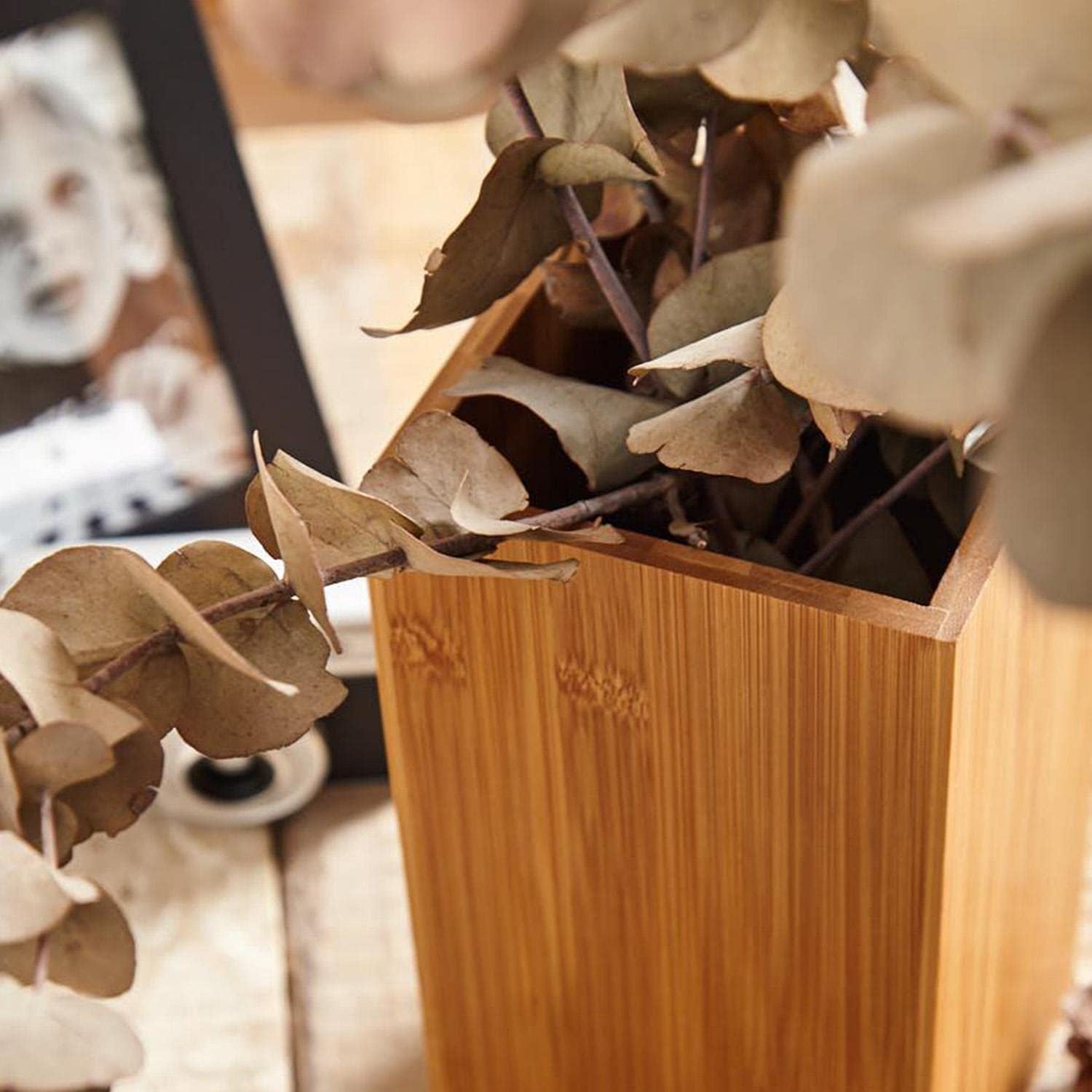 Wooden Spoon Holder used creatively as a plant pot, demonstrating its versatility beyond kitchen storage.