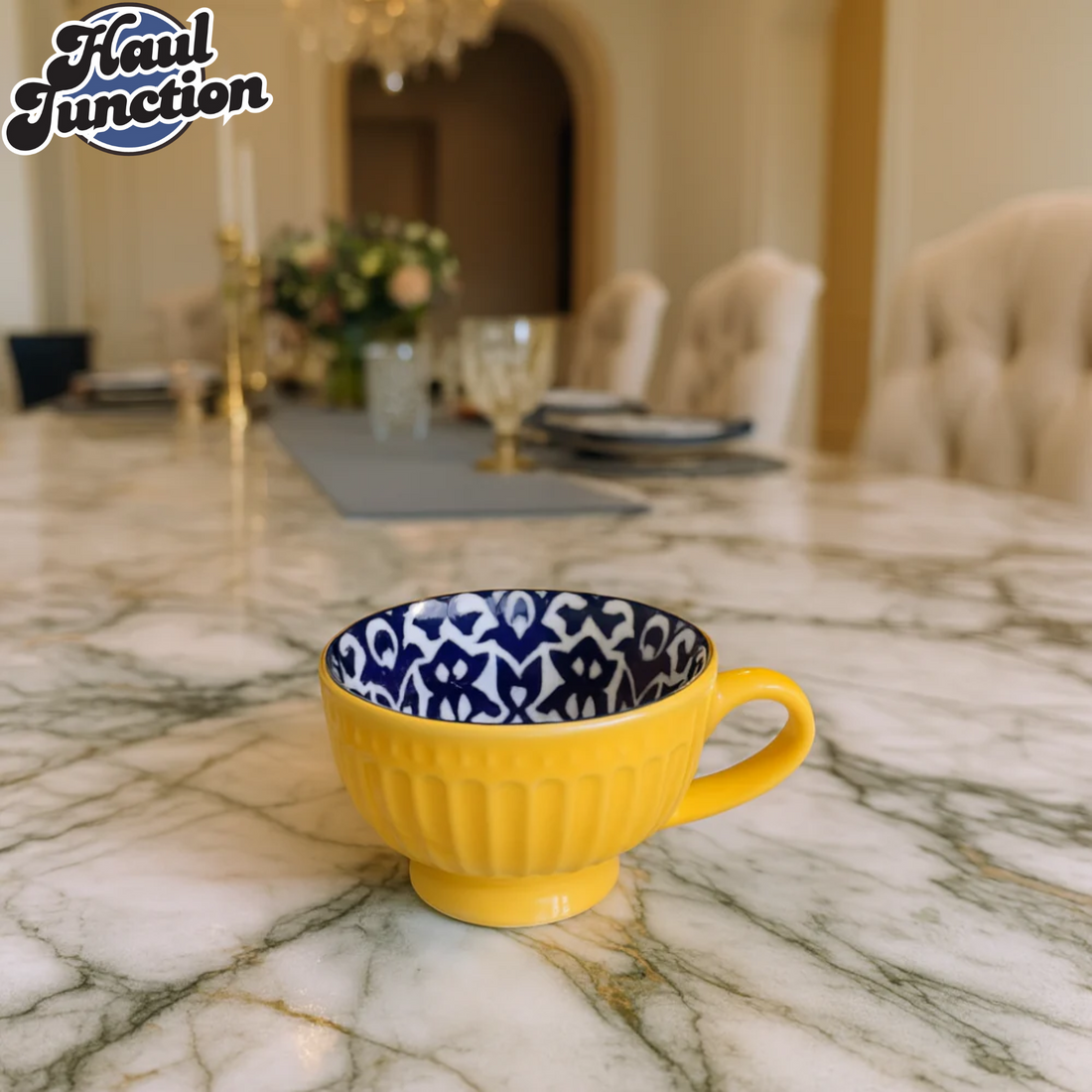 Yellow mug with blue and white patterned interior on a marble surface, blurred dining room background.