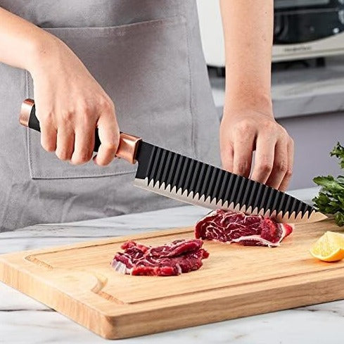 Large black knife slicing a steak, emphasizing its efficiency for meat preparation.