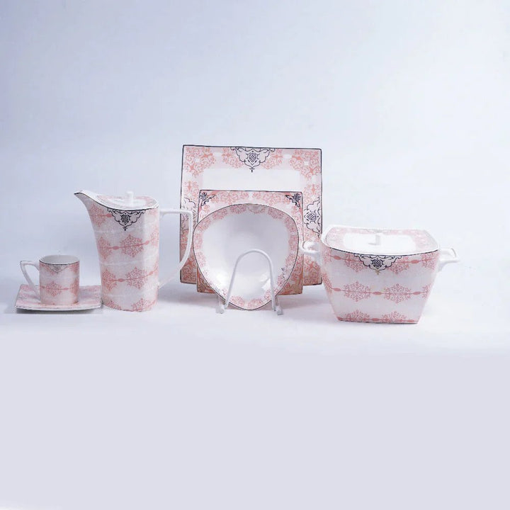 3 sizes of bone china pink white black plates, saucer, jug, mug, and a hotpot bowl with lid displayed on a table.