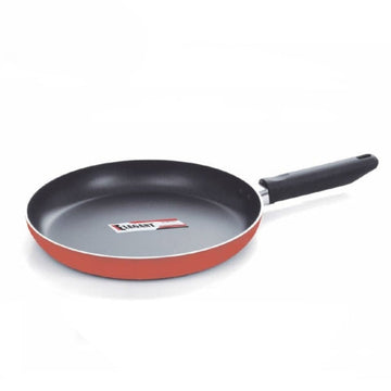 Frying pan with red exterior and black interior on a white background