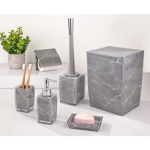 Complete grey and white marble bathroom set displayed on a white bathroom countertop, showcasing elegance and style.