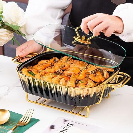 Showcasing the large black gold food warmer with lid in hand, filled with food.