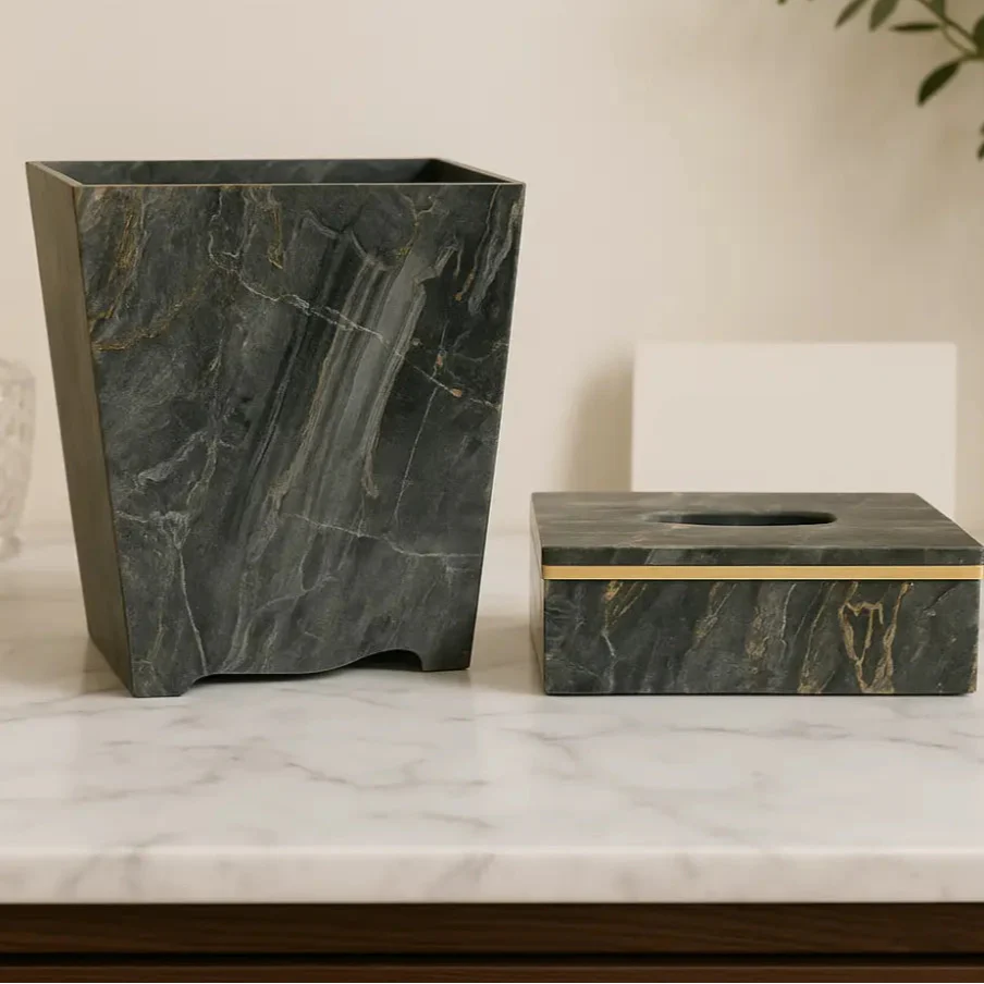 Marble-patterned trash can and tissue box on a marble surface with a neutral background