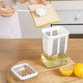 Person spreading greek youghurt on toast with a kitchen tool, surrounded by lemons and a container of honey.