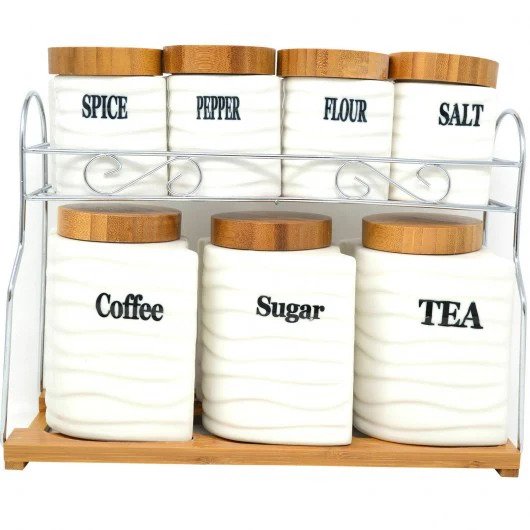 Showcasing the set of 7 ceramic storage jars placed on a steel stand with a wooden base, featuring wave texture, labeled jars, and wooden lids, all in a white background.